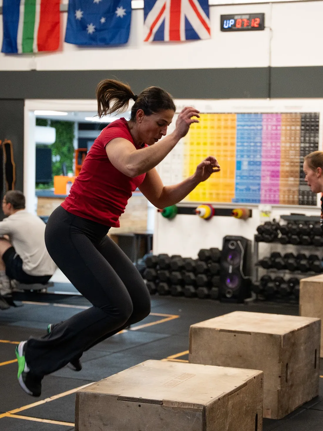 A member mid box jump during the workout